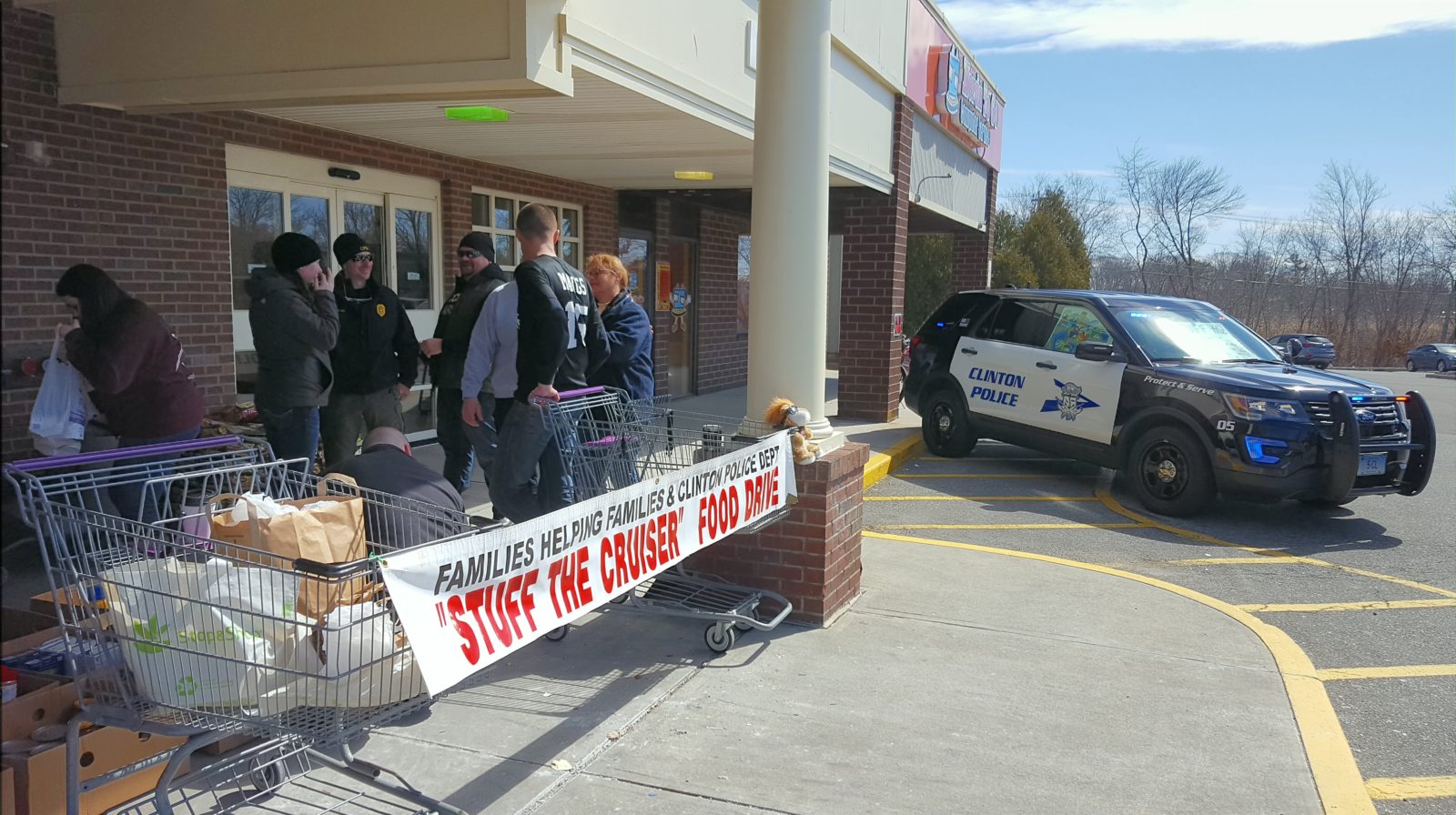 Police officers outside a building with a COVID-19 testing sign.